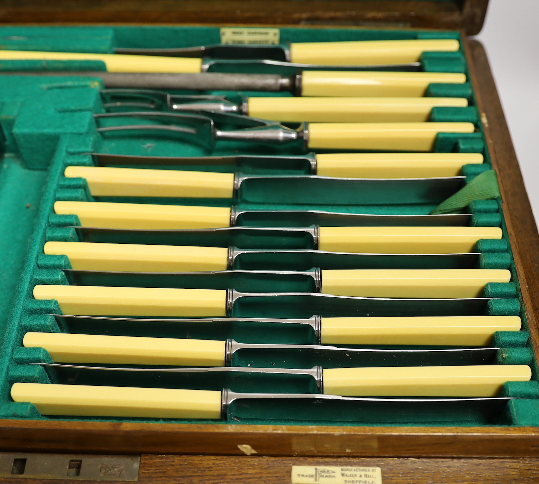 An almost complete George VI Art Deco silver canteen of cutlery by Walker & Hall comprising seventy five items, 119.6oz, together with eleven ivorine handled table knives and twelve dessert knives (two with replaced hand